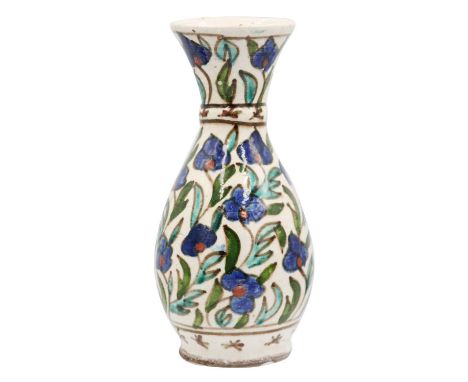 A Turkish Isnik pottery baluster vase, 19th century. With painted polychrome floral decoration, height 16cm, width 7cm.The Va