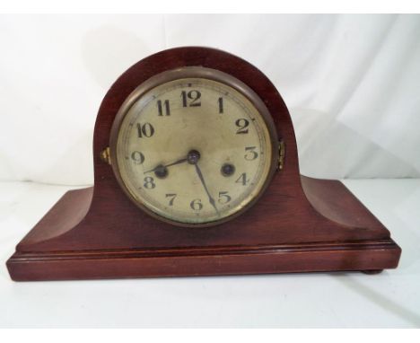 A mahogany Napoleon's hat styled mantel clock, brass bezel over silvered ial with Arabic numerals, 8-day movement by Gustav B
