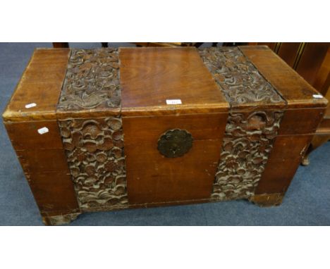 A 1920S CAMPHOR WOOD TRUNK with carved lotus decoration, 83.5cm wide