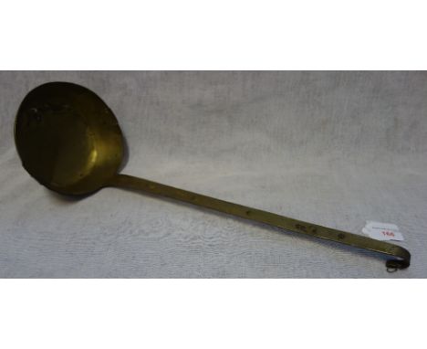 A LARGE 18TH CENTURY BRASS LADLE, with old repairs and stamped marks to the handle
