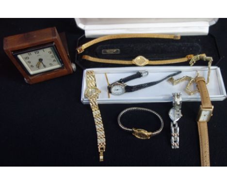 A COLLECTION OF WRISTWATCHES and a travelling clock