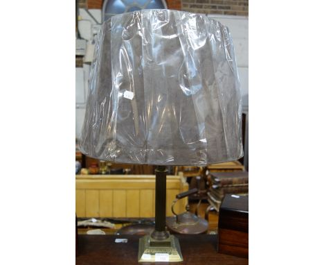 A BRASS CORINTHIAN COLUMN TABLE LAMP with a pleated shade