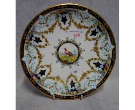 A ROYAL WORCESTER CABINET PLATE decorated with a tropical bird within a Royal blue and gilt swag border, 21.5cm dia.