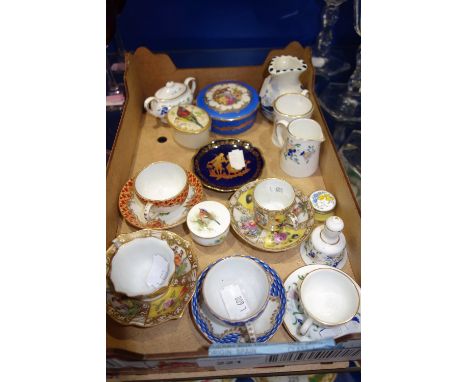 A ROYAL WORCESTER PILL BOX PAINTED WITH A BIRD, a collection of miniature cups and saucers and other items