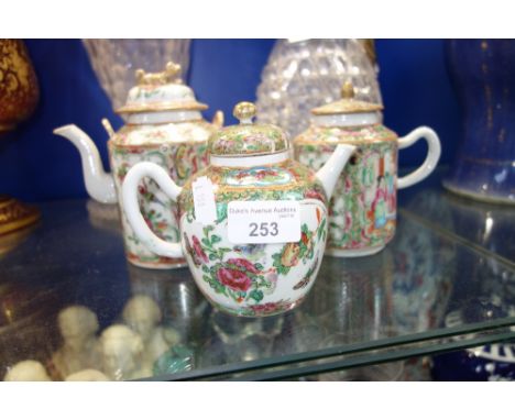 A CHINESE FAMILLE ROSE TEAPOT, 12.5 cm high and two similar (3)