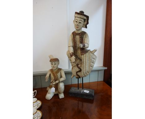 A BURMESE/THAI WOODEN STUDY OF A DANCING MAN with white crackled paint work and mirrored gilding, on a wooden base with metal