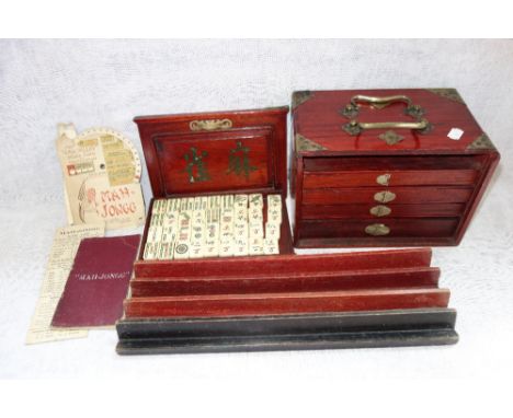 A MAHJONG SET, in a fitted wooden box with brass furniture 