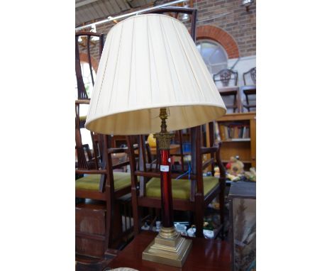 A BRASS CORINTHIAN COLUMN TABLE LAMP, with a red glass pillar, 52 cm high (not incl fitting)