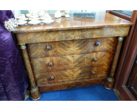 A 19TH CENTURY EMPIRE STYLE MAHOGANY COMMODE, with three drawers and a concealed frieze drawer  flanked by columns with gilt 