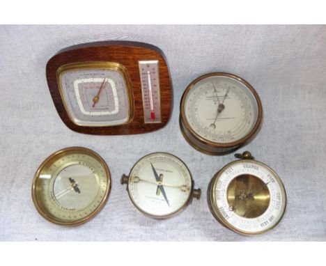 AN ANEROID BAROMETER, the dial inscribed 'T.A. Reynolds Son & Wardale Ltd London', and a collection of similar barometers