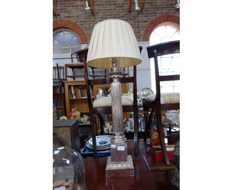 A LARGE SILVER PLATED TABLE LAMP, with a reeded column on a square plinth, 56 cm high (plus fittings)