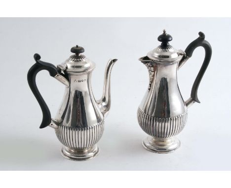 A SMALL BALUSTER COFFEE POT with a part-flued lower body, by Wakely & Wheeler, London 1956 and a hot milk jug of similar form