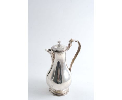 A GEORGE III BALUSTER HOT WATER JUG with bead borders, a knop finial & a cord-bound scroll handle, crested, by Thomas Heming,