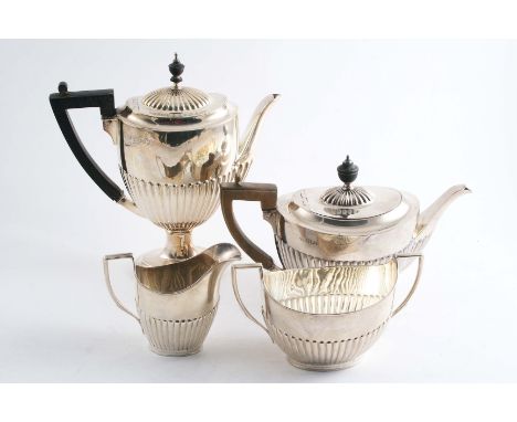 A LATE VICTORIAN THREE PIECE COFFEE SET with part-fluted bodies & angular handles, by Edward Hutton, London 1884 and a tea po