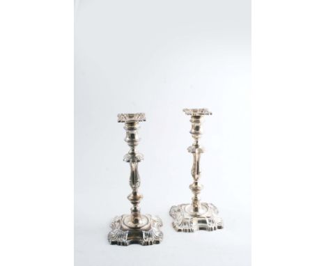 A PAIR OF CANDLESTICKS  on shaped square bases with knopped columns & shell decoration at the corners, detachable nozzles, by