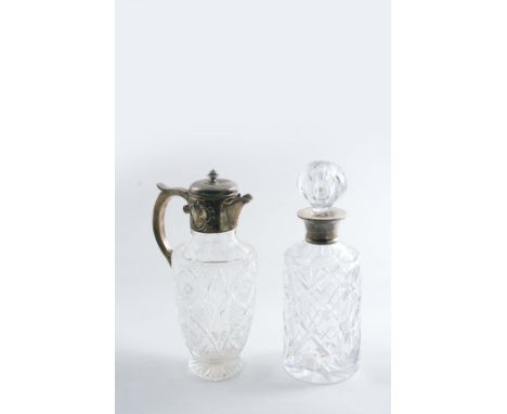 A LATE VICTORIAN MOUNTED CUT GLASS CLARET JUG with a tiered knop finial, by W. Gibson & J. Langman, London 1899 and a modern,