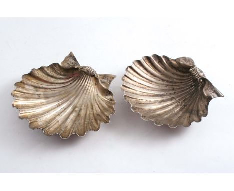 A GEORGE IV BUTTER SHELL on two small cast periwinkle feet, engraved with two crests, by Paul Storr, London 1824 and another 