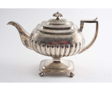 A GEORGE III COFFEE POT with a pedestal base & ball feet, the body decorated with part-fluting and an engraved frieze around 