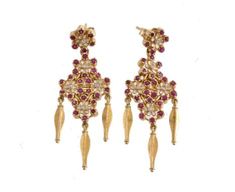 A pair of enamel, ruby and diamond flower head earrings, the white enamel flower head panels set with circular cut rubies and