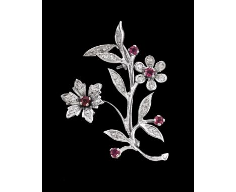 A 1960s 18 carat gold diamond and ruby floral spray brooch, the floral spray set with eight cut diamonds and ciruclar cut rub