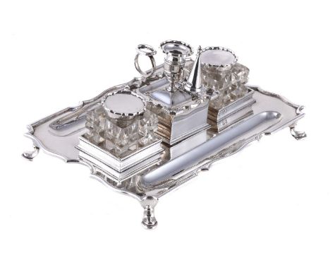 A silver shaped rectangular inkstand by The Goldsmiths & Silversmiths Co. Ltd, London 1910, with a removable shaped square ch