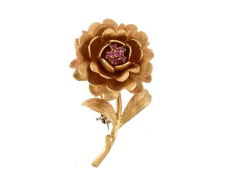 A 1960s 18 carat gold ruby flower head brooch, the flower with a textured finish, set with a cluster of circular cut rubies, 