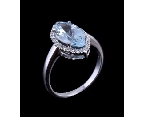 An aquamarine and diamond ring, the marquise cut aquamarine claw set within a surround of brilliant cut diamonds, approximate