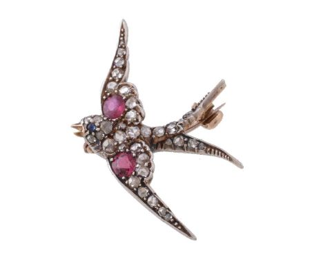 A late Victorian diamond, ruby and sapphire swallow brooch, circa 1890, set with rose cut diamonds and each wing set with a c