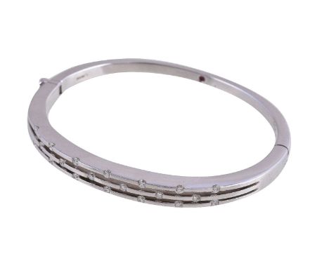 An 18 carat gold diamond bangle, the hinged bangle set with brilliant cut diamonds, approximately 0.40 carats total, stamped 