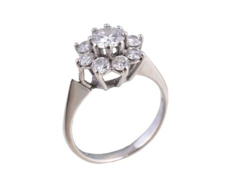 A diamond cluster ring, the central brilliant cut diamond in a claw setting, within a surround of further brilliant cut diamo