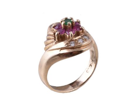 A ruby, diamond and emerald cluster ring, the central circular cut emerald within a surround of circular cut rubies and brill