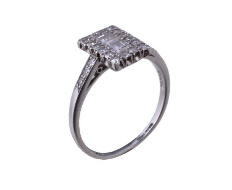 A 1930s diamond ring, the rectangular panel set with square cut diamonds within a surround of eight cut diamonds, to eight cu