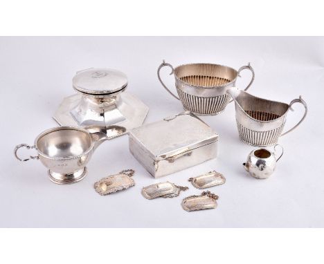 A collection of silver, including: an octagonal large capstan inkwell by A. & J. Zimmerman, Birmingham 1921, engraved with a 