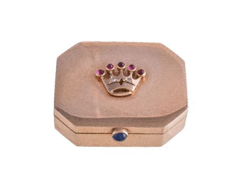 A gem set gold coloured canted-rectangular pill box, stamped 18K, circa 1950, the cover with an applied cabochon ruby and ros