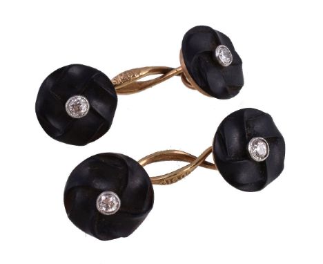 A pair of black stone and diamond cufflinks, the carved stone panels each set with an old brilliant cut diamond, the connecto