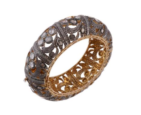 A diamond bracelet, the pierced bangle set with polki diamonds, 6.2cm inner width, 90g