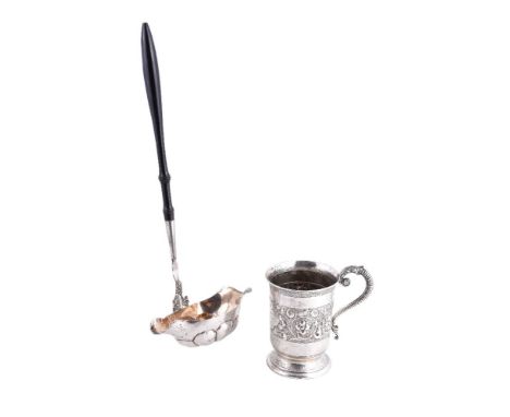 A Victorian silver christening mug by Robert Harper, London 1866, with a leaf-capped ribbed S-scroll handle, a slightly evert