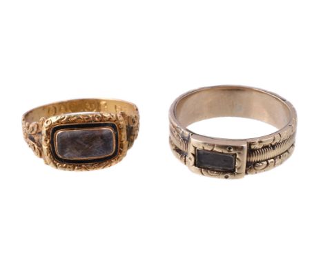 A Georgian 18 carat gold mourning ring, the glazed panel with plaited hair beneath, within a black enamel surround, on a chas