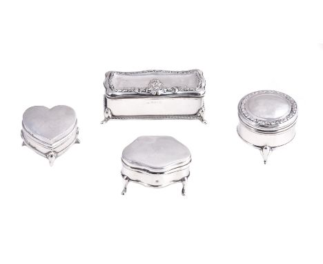 Four various silver dressing table boxes, the first heart shaped by Levi & Salaman, Birmingham 1910, 4cm (1 1/2in) long; the 