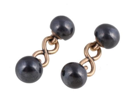 A pair of hematite cufflinks, the polished hematite terminals with gold coloured figure of eight connectors