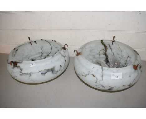 A pair of circular marbled glass light shades