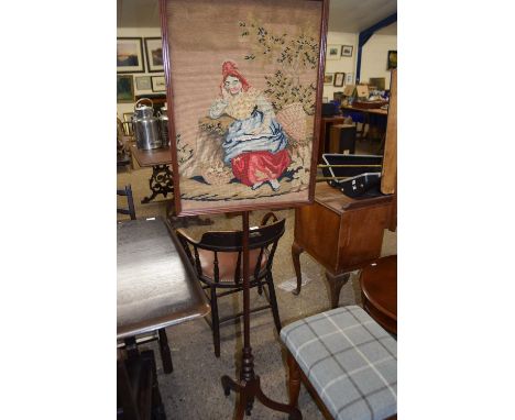 19th Century mahogany pole screen decorated with a tapestry panel depicting a peasant woman