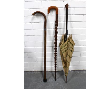 Walking stick with a carved snake, 88cm, together with a walking stick with a white metal collar and a vintage parasol (3)