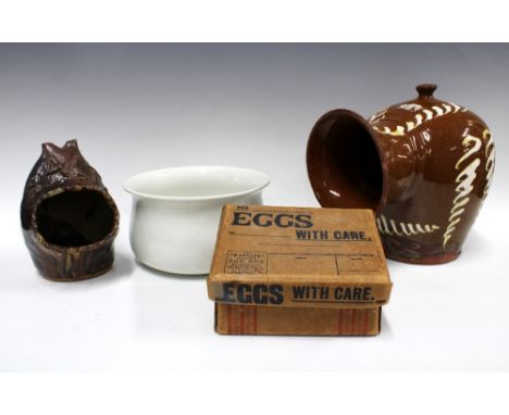 A large slipware salt jar, 27cm, together with another smaller, a chamber pot, and a vintage cardboard egg box (4) (some dama