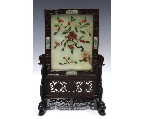 A Chinese hardstone table screen with flowers and foliage pattern, the rectangular plaque mounted in a reticulated wooden sta