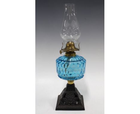 Early 20th century oil lamp with blue glass well, 41cm