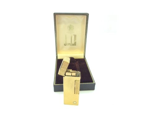 A gold plated engine turned Dunhill cigarette lighter in original presentation case.