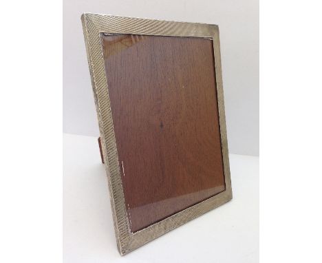 An engine turned silver photograph frame.