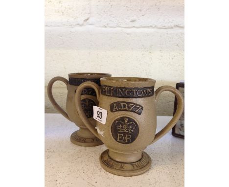 A pair of Poole Pottery Queen Elizabeth II Silver Jubilee twin handled stoneware loving cups.