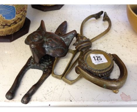 An early 20th century brass fox head door knocker together with another brass door knocker and a pair of brass tongs.